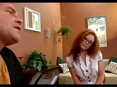 Nerdy redhead secretary Audrey Hollander keeps her job by sucking and fucking the boss